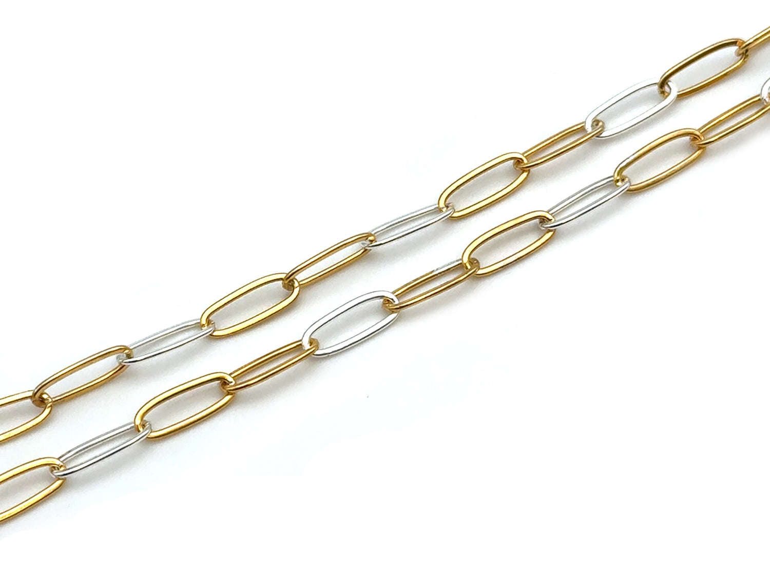 A two-tone paperclip chain necklace featuring alternating gold and silver oval links, displayed diagonally on a clean white background.