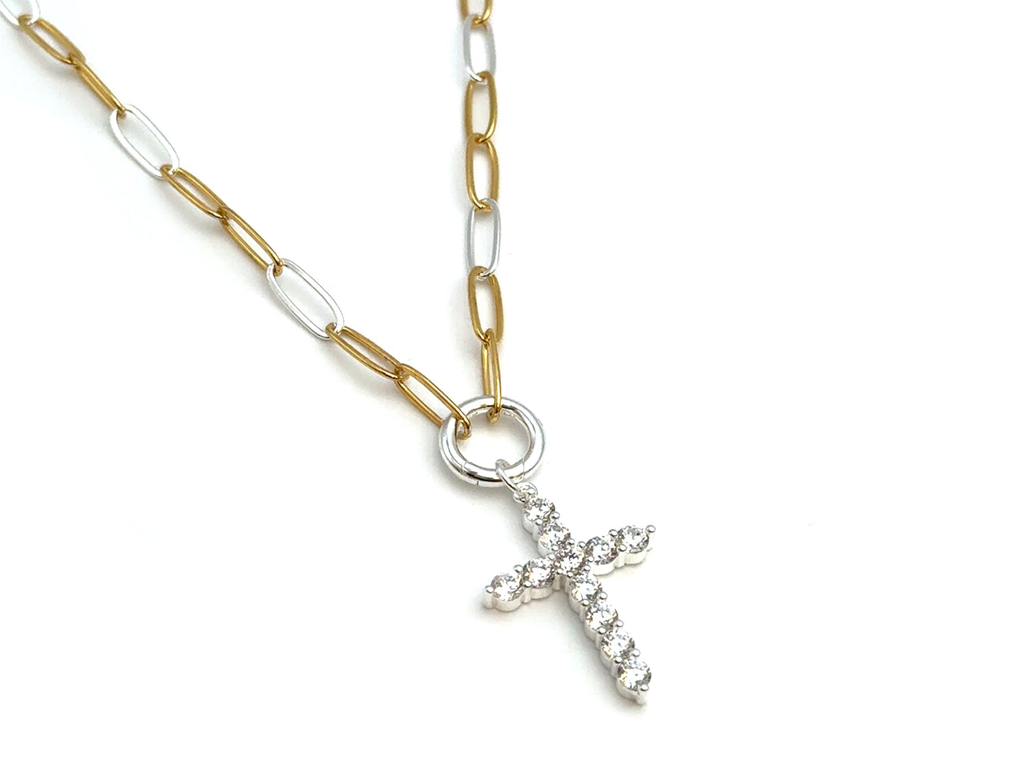 A two-tone chain necklace featuring a gold and silver paperclip link chain with a silver cross pendant adorned with small clear crystals, shown on a plain white background.