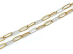 A two-tone paperclip chain necklace featuring alternating gold and silver oval links, displayed diagonally on a clean white background.